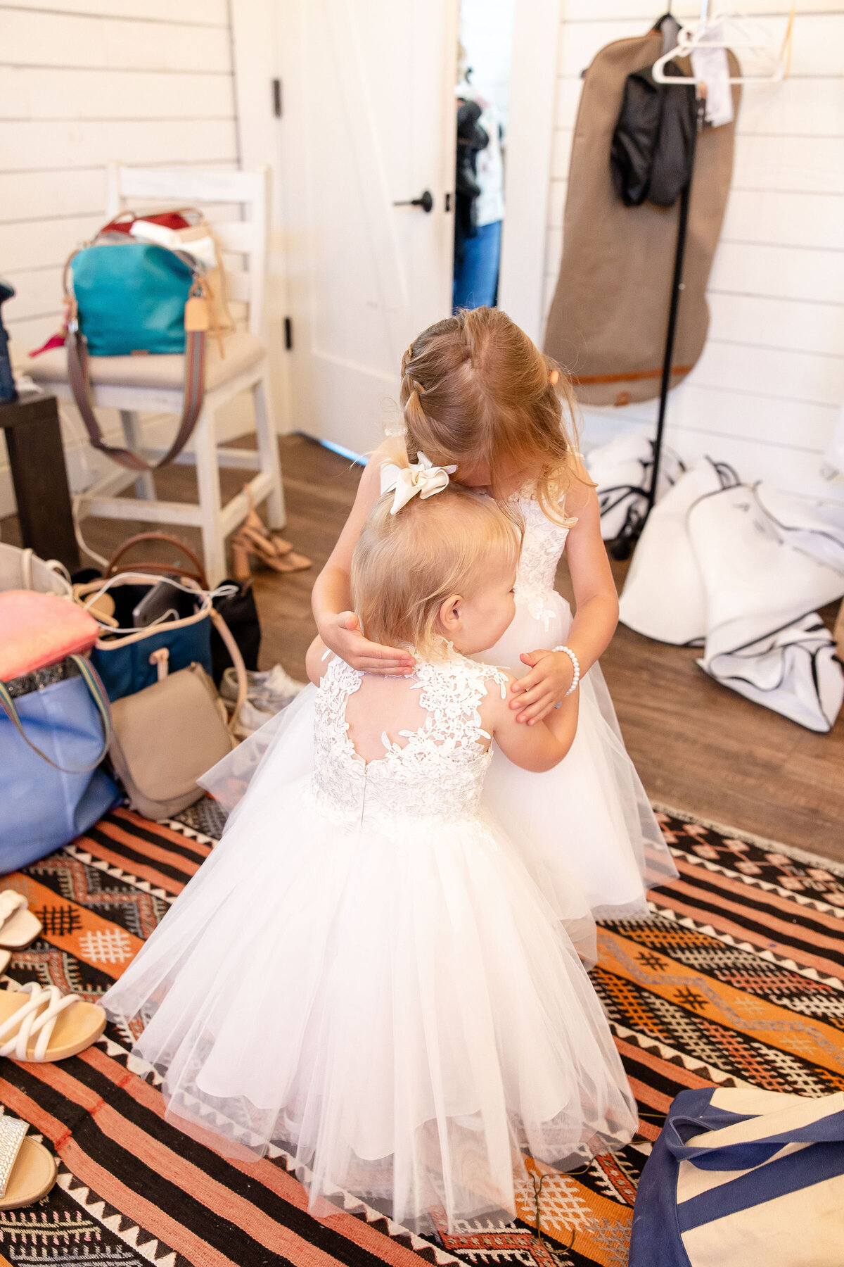 toddler flower girls hug captured by Firefly Photography