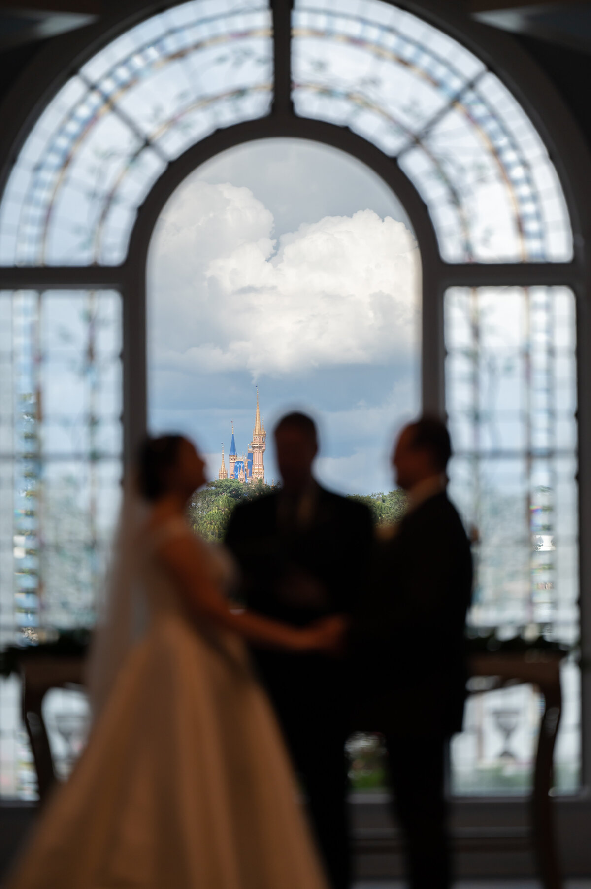 Wedding Pavilion Wedding, Cinderellas Castle in focus, couple and officiant blurry