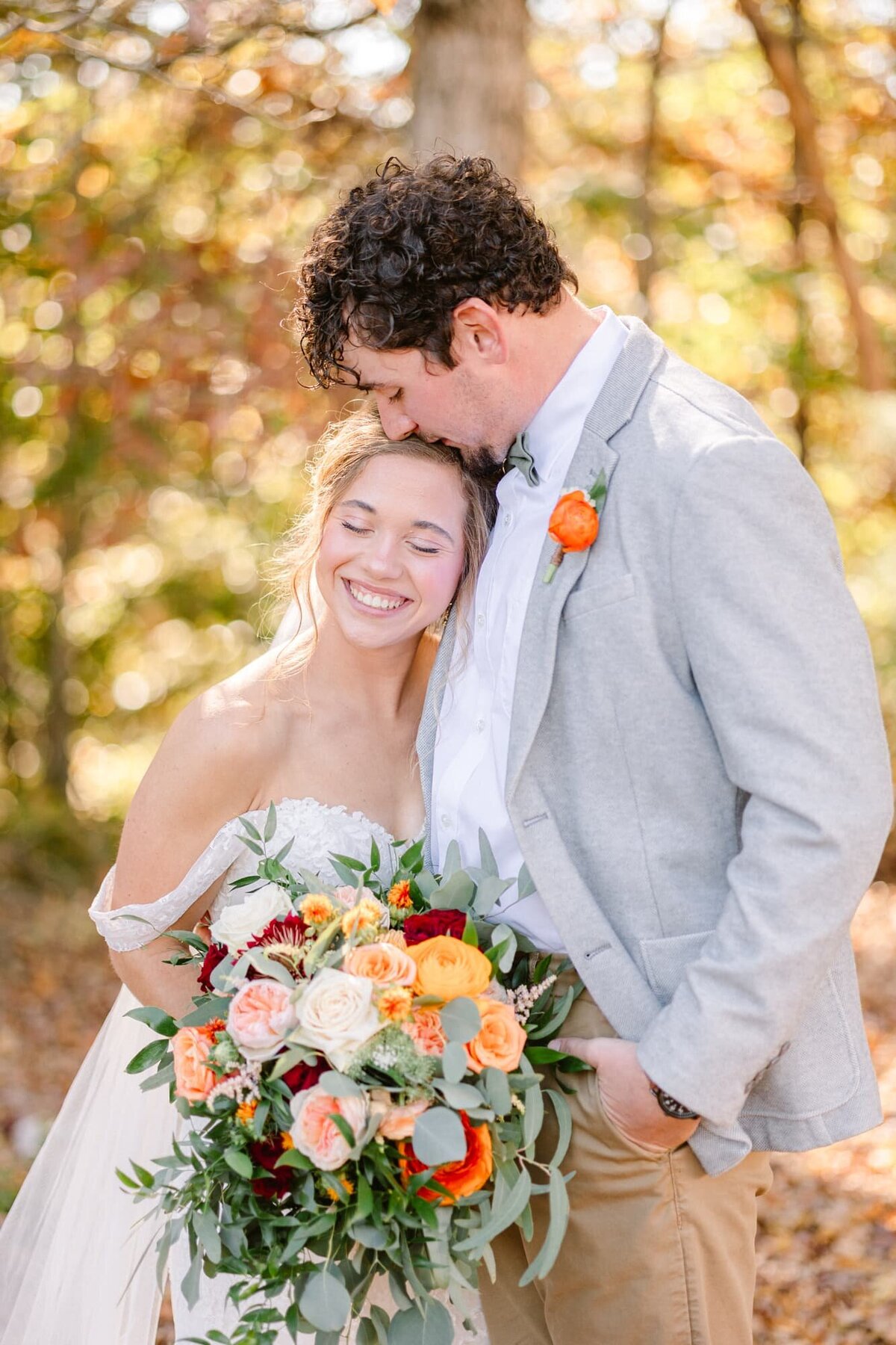 Groom kisses bride's head at farm wedding near Charlottesville VA