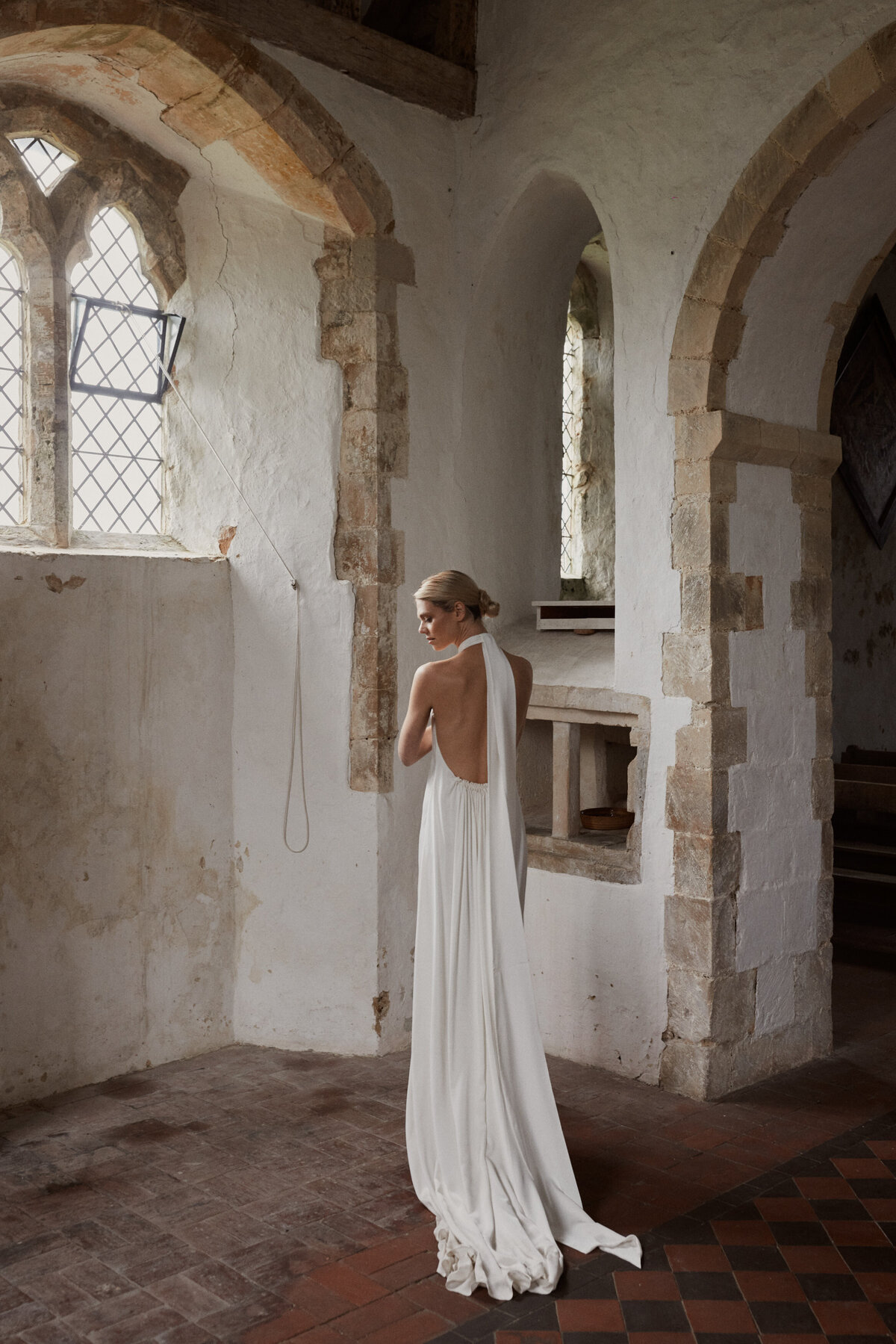 Sleeveless silk halter neck wedding dress by UK bridal gown designer on bride