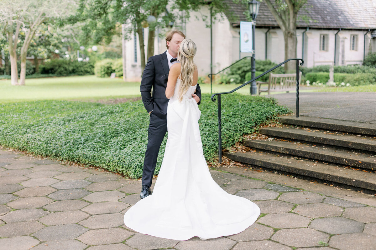 Bride and groom kissing in their wedding venue
