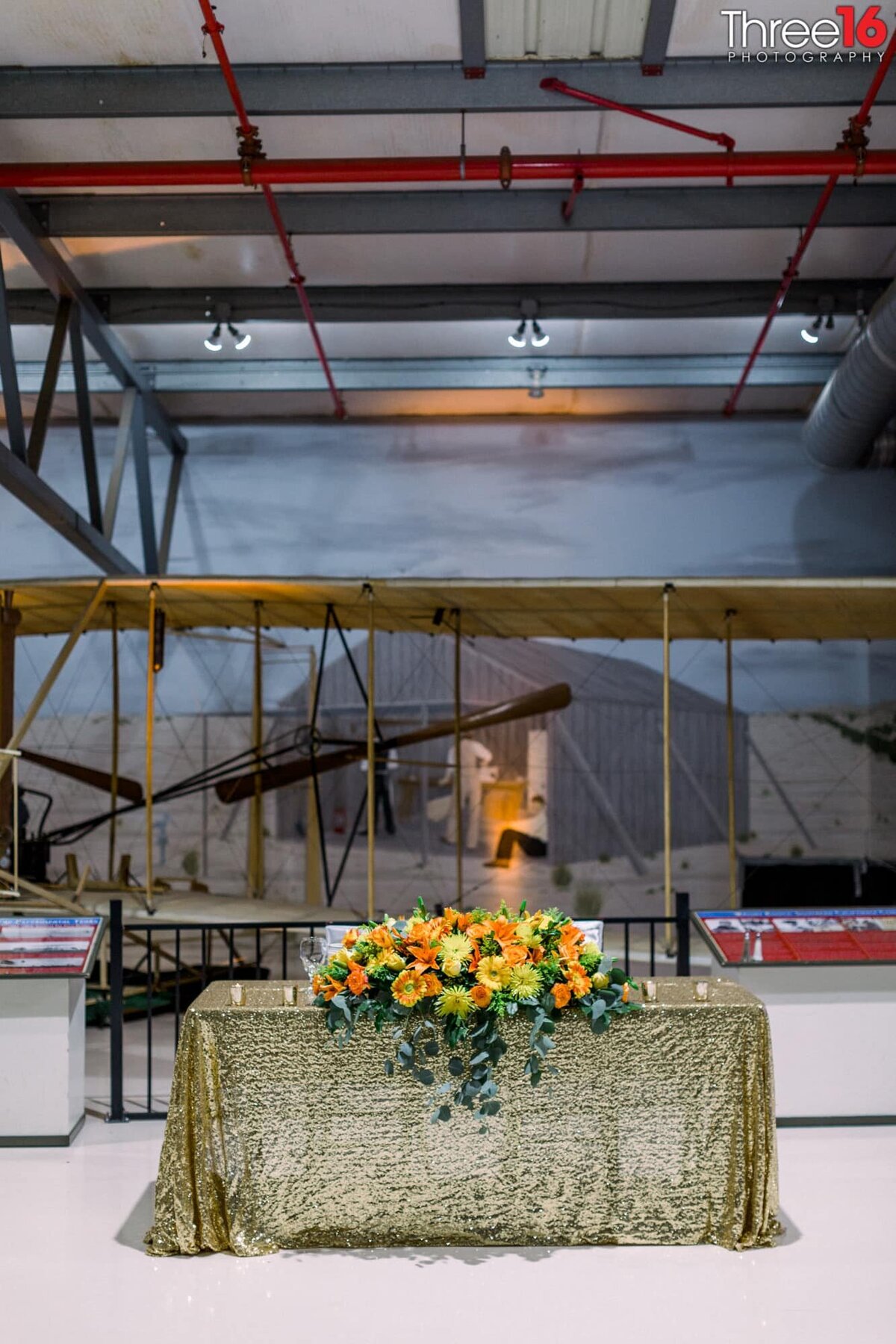 Sweetheart table setup for wedding reception inside a hangar at the Planes of Fame Air Museum