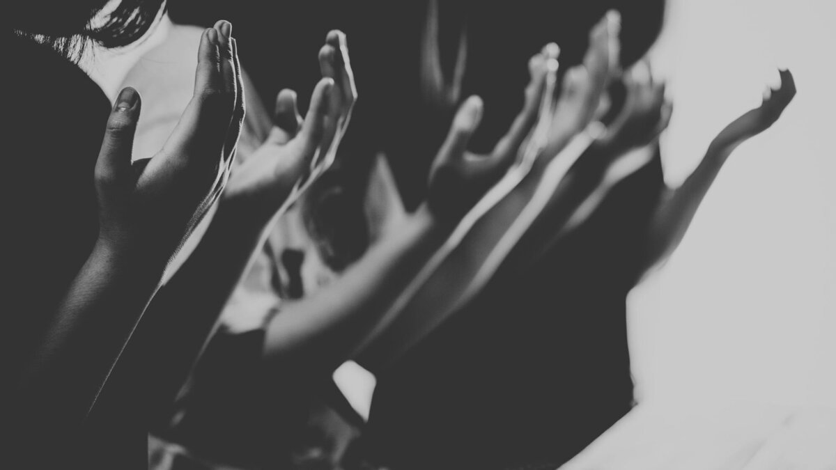A community of believers lifting their hands in worship at The Gathering, encountering the presence of God in Colorado Springs.