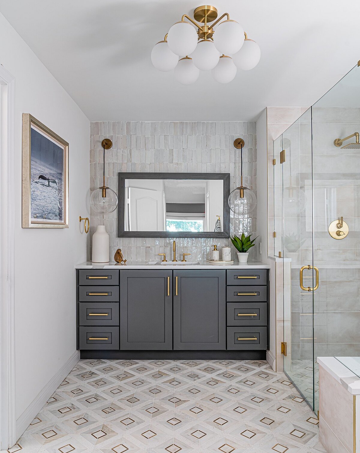 coastal luxury home Master Bathroom gray vanity with brass accents full service interior design by Island Home Interiors Lake Nona