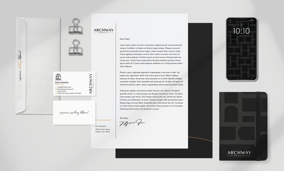 Flat lay of Archway Group’s brand suite including stationery, business card, mobile UI, and presentation folder.