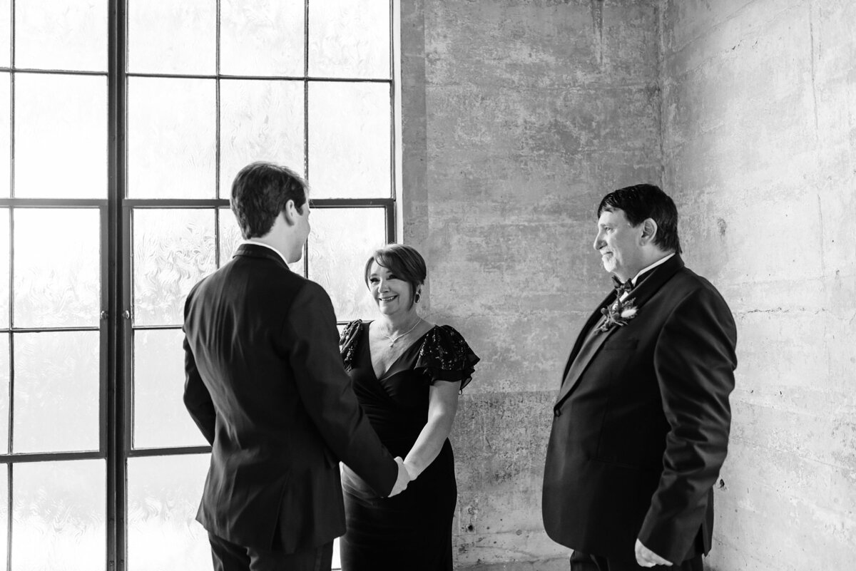 Bride's mother embracing the groom during their first look in the chapel at Olde Dobbin Station.