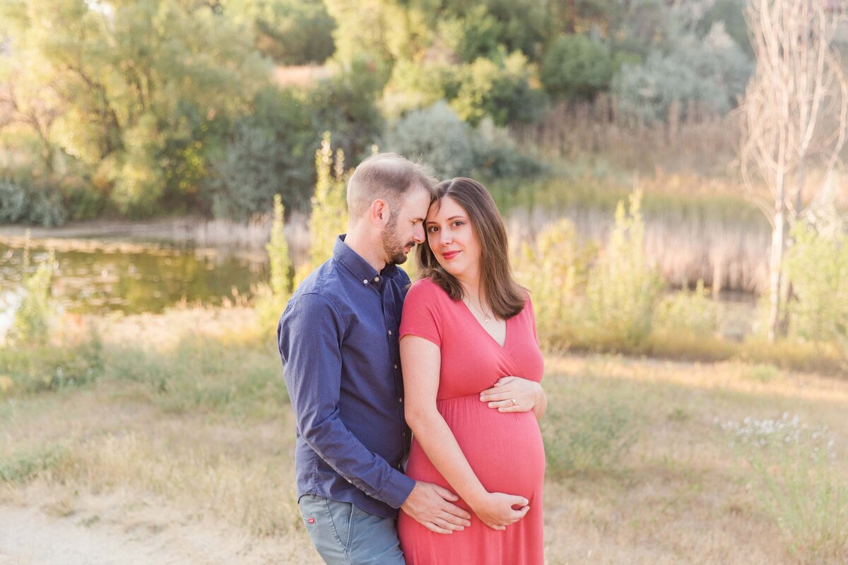 husband nuzzles wife during maternity session