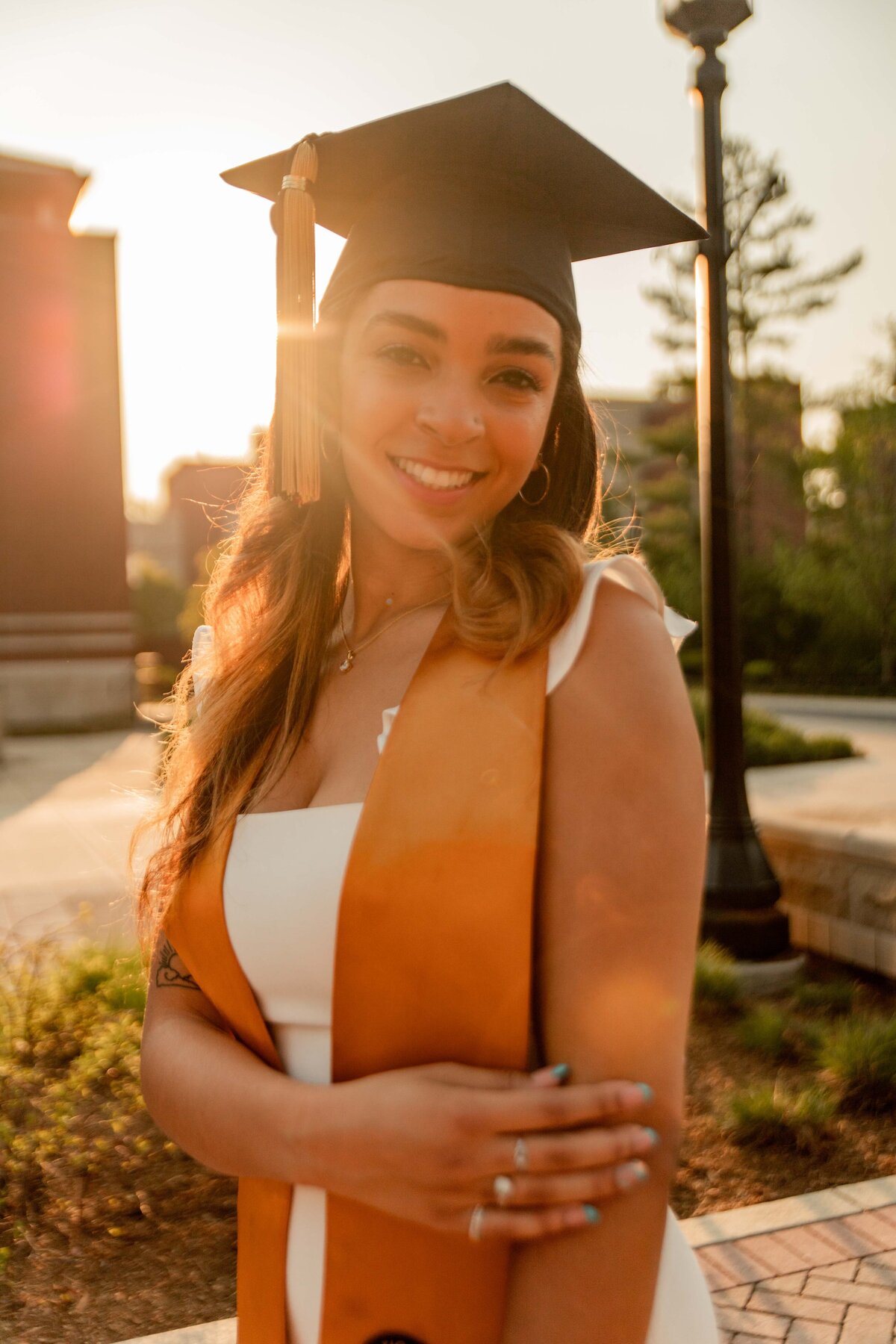 cap and gown in sunset  for college graduate.