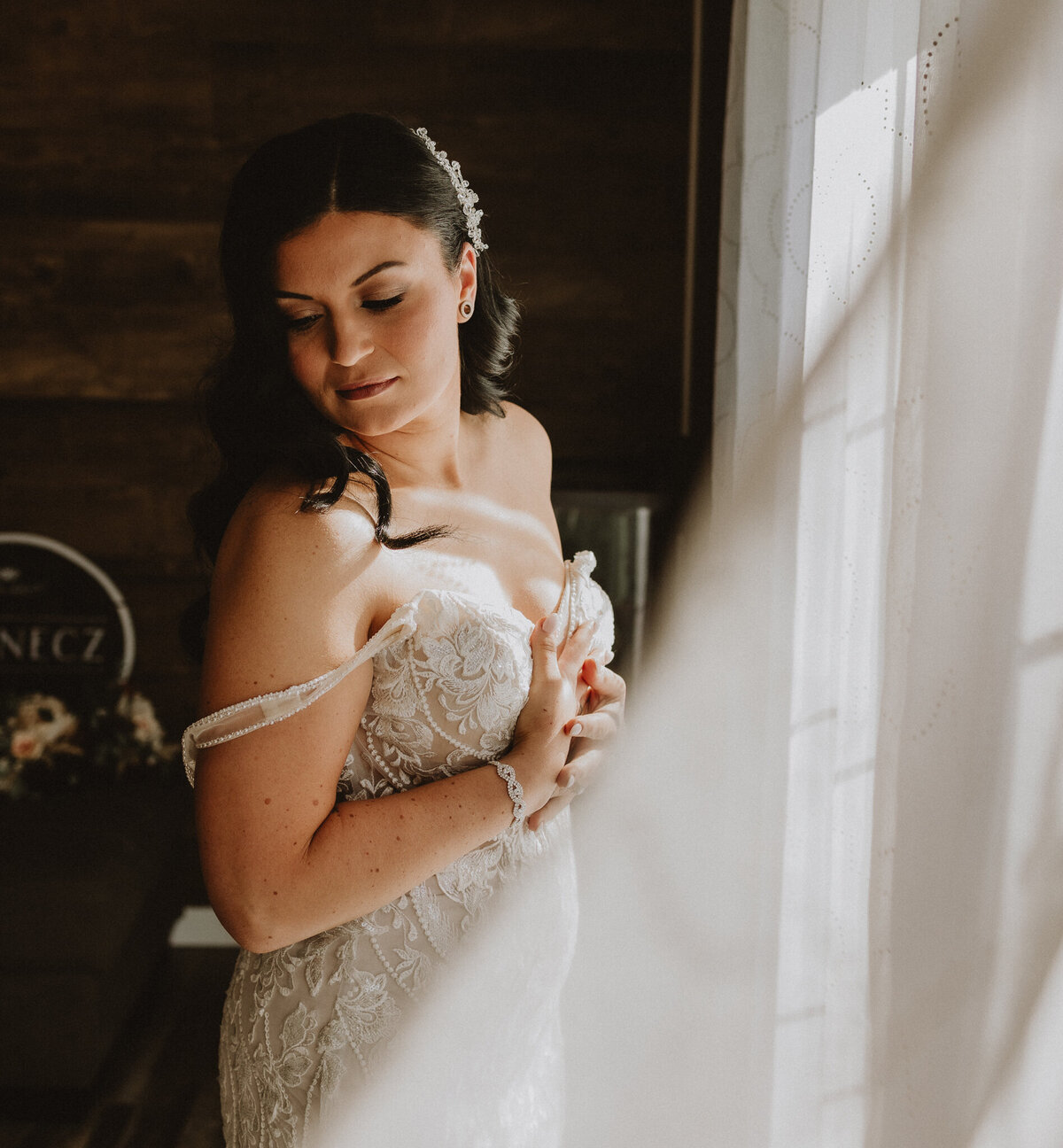 Bride putting on dress in home at lac la biche