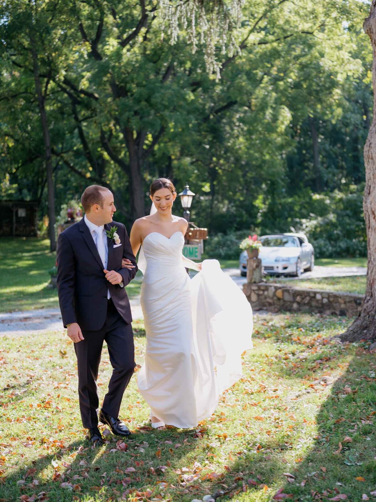 Bride and groom walking moment during their private residence tented wedding.