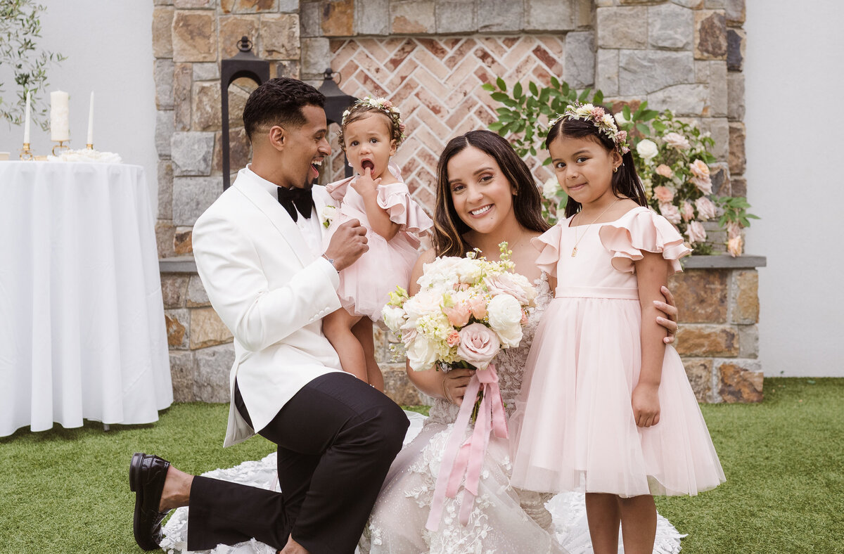 cute photo with flower girls and bride and groom