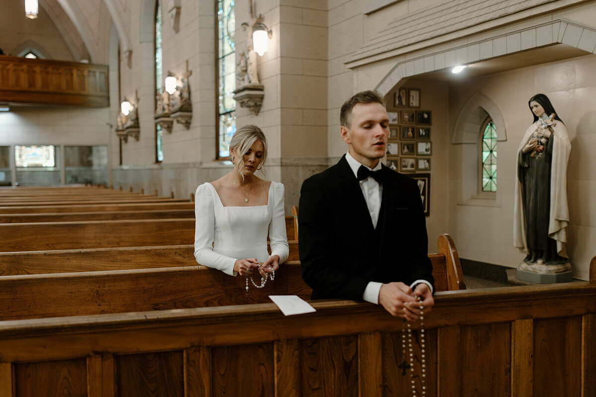 bride and groom praying a rosary