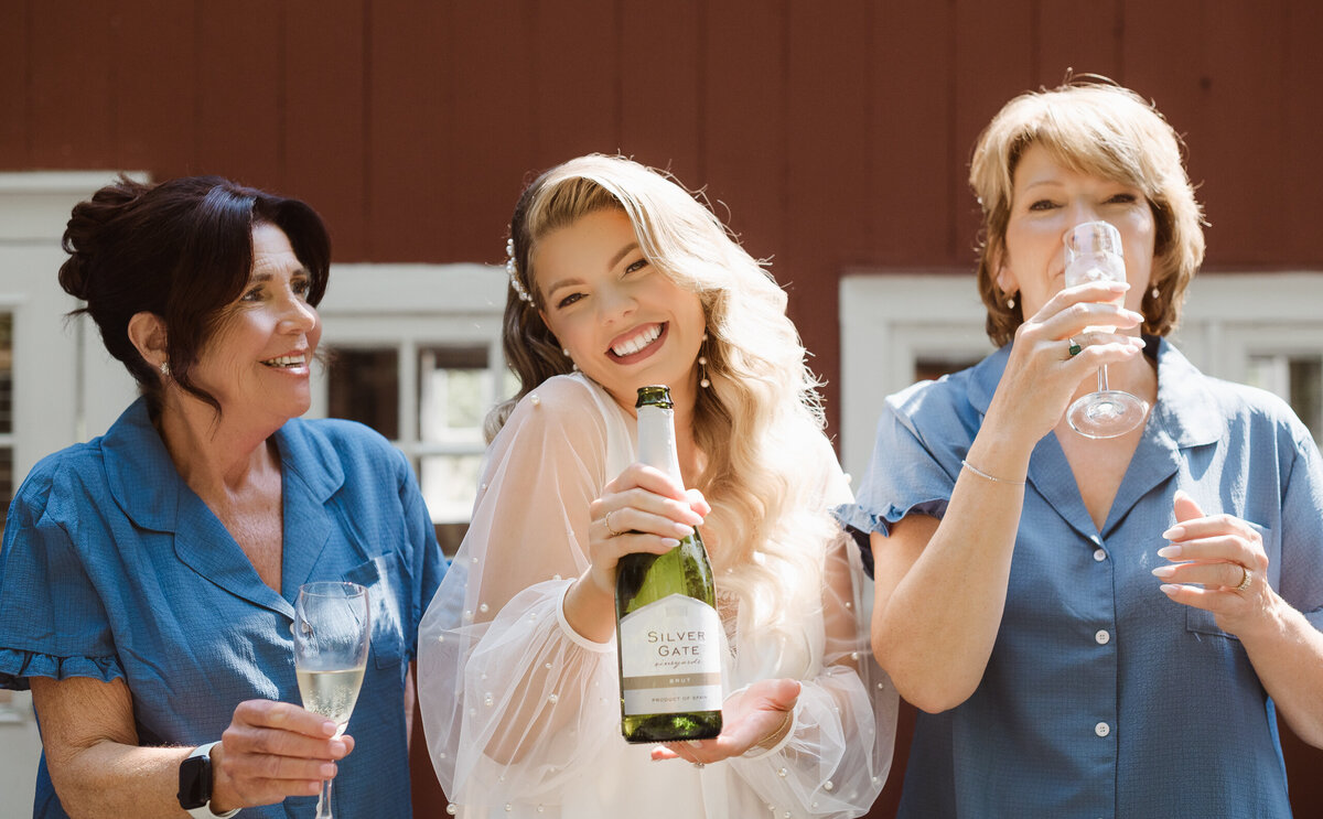 popping champagne outside the bridal suite at the inn at millrace pond nj