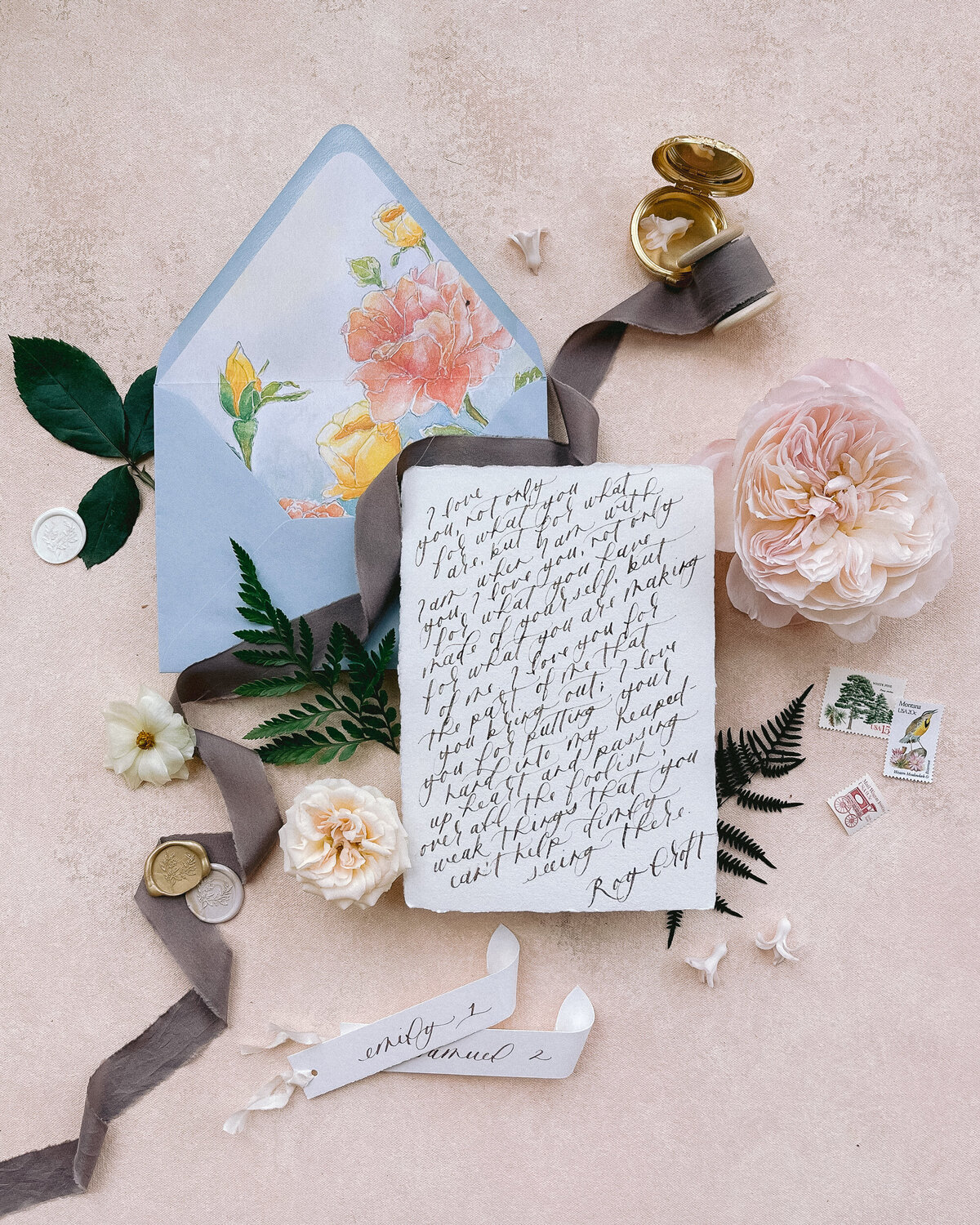 Handwritten love letter in calligraphy with a watercolor envelope liner and scrolled place cards