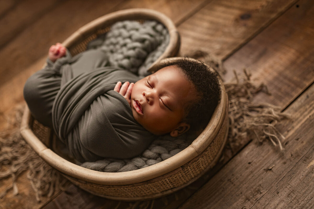 baby wrapped and posed in baby heart prop