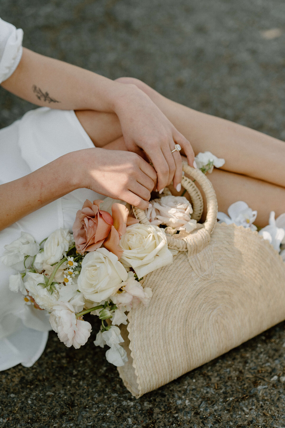 bride holding a bag with florals