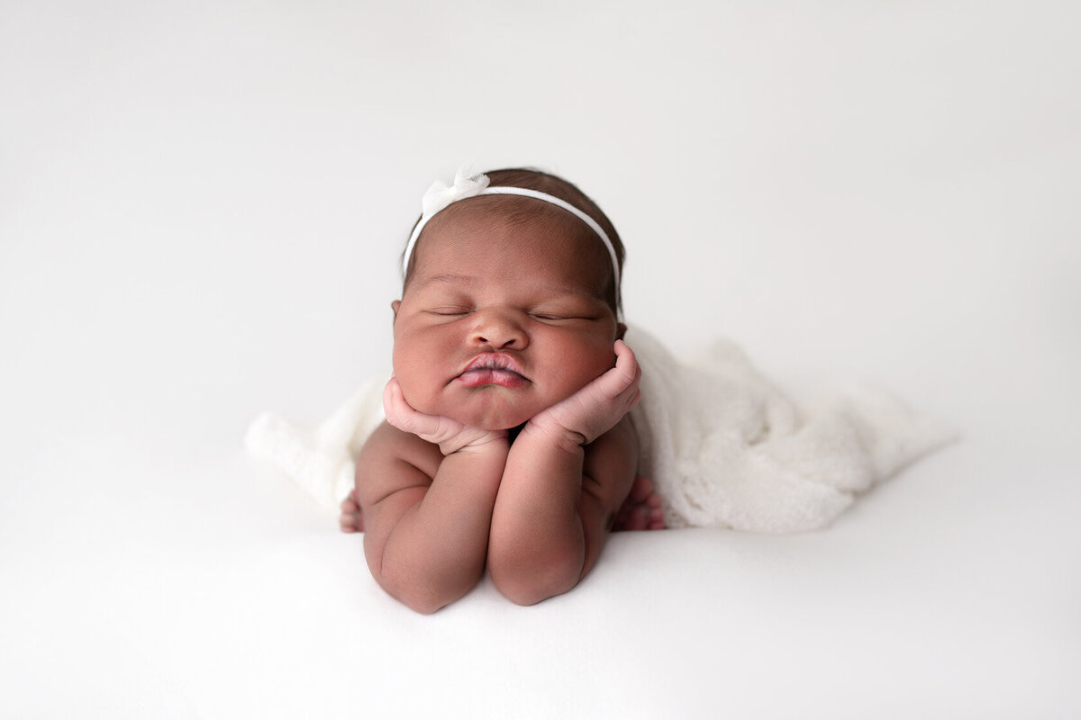 Chin on hands newborn photography by Laura King