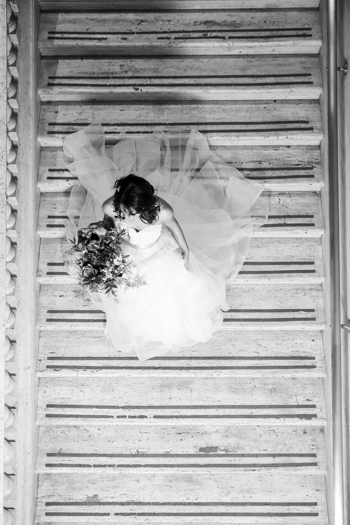A bride descends down the stairs for her wedding ceremony in Chicago, IL.