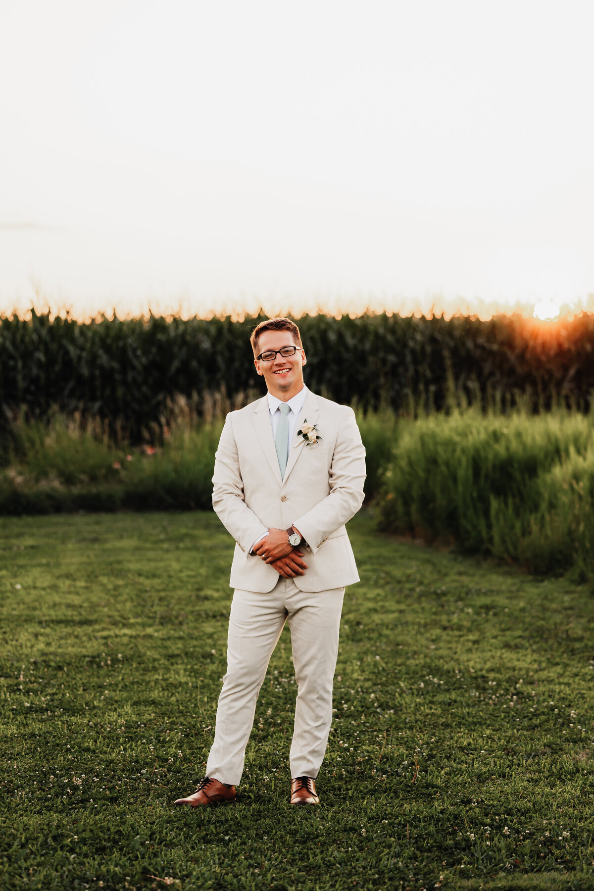 A portrait of a groom in sunset.