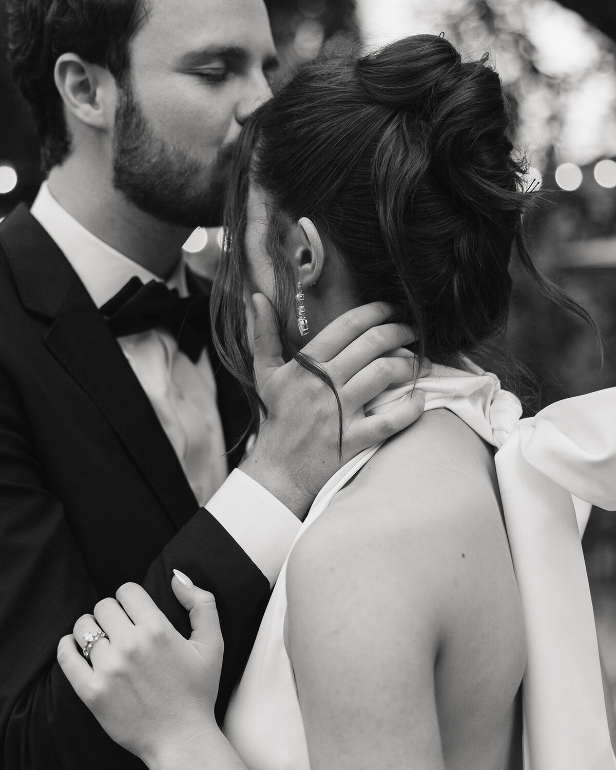 groom kisses bride's forehead