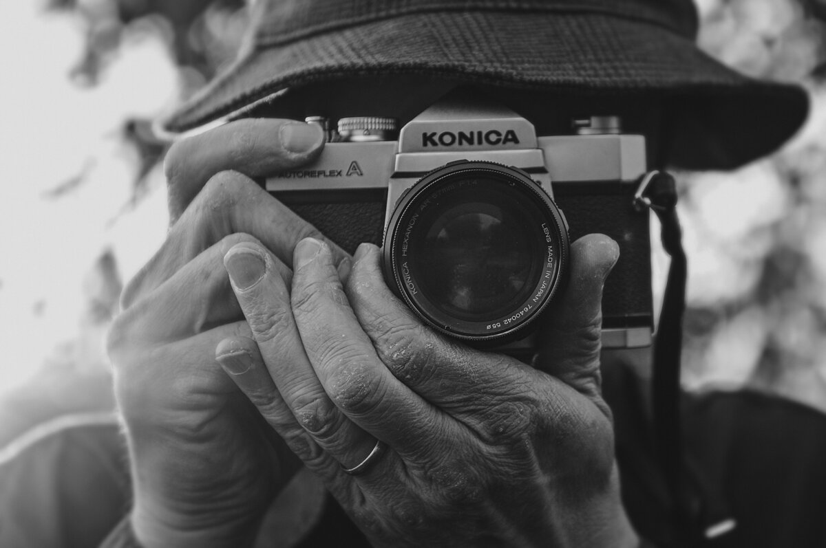 A black and white photo of a person taking a photo