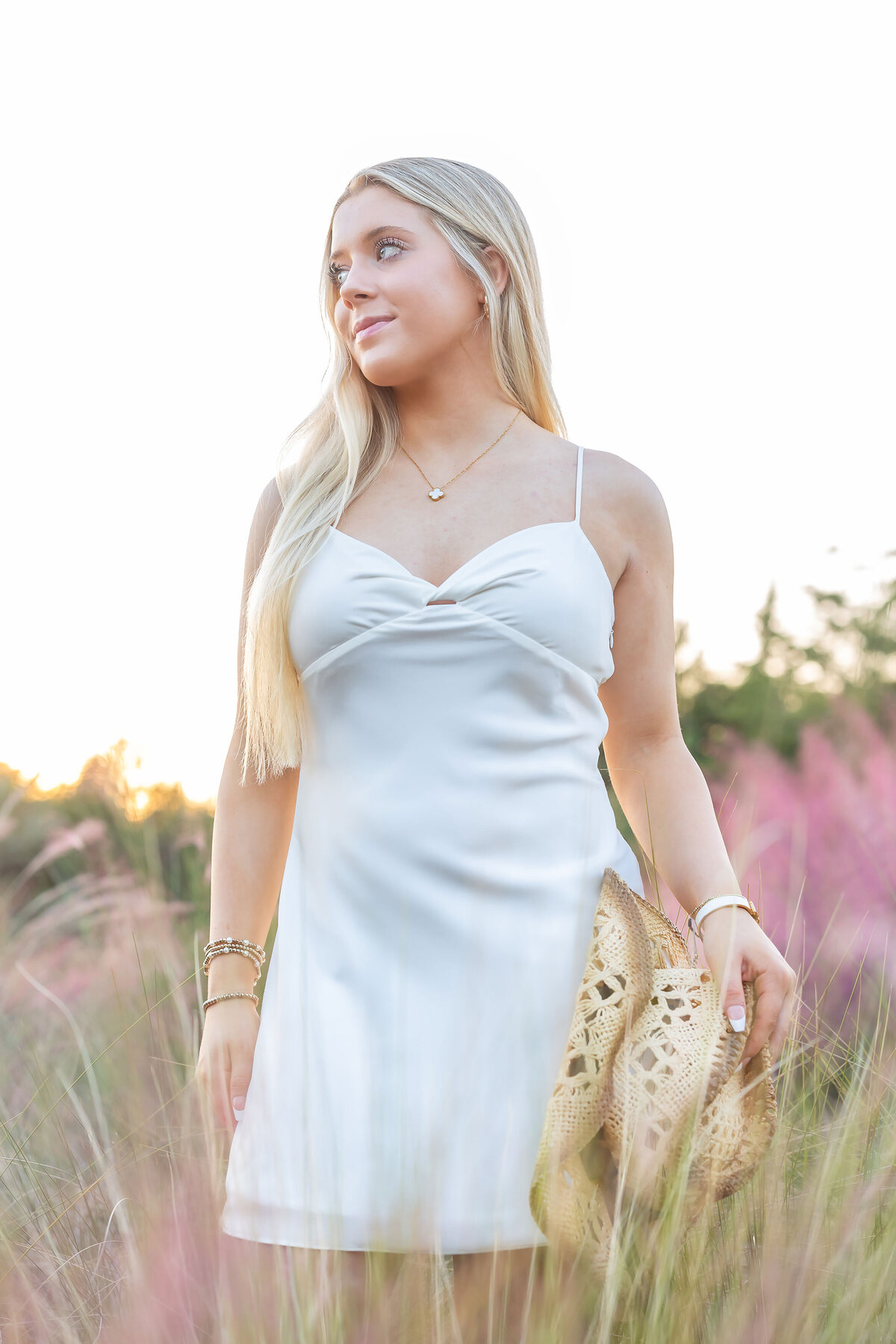 Elegant graduation portrait of a beautiful woman in a white dress, part of a Senior Photography Portfolio showcasing timeless and stylish senior photos.