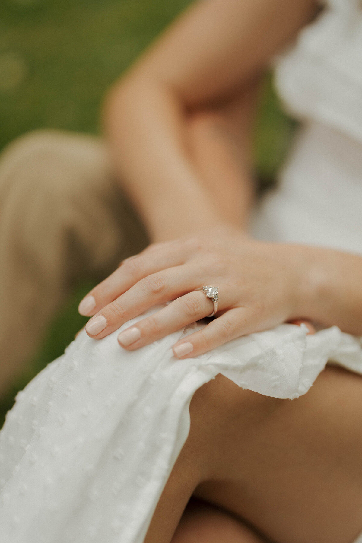 Engagement ring at engagement session by April Graber Photography