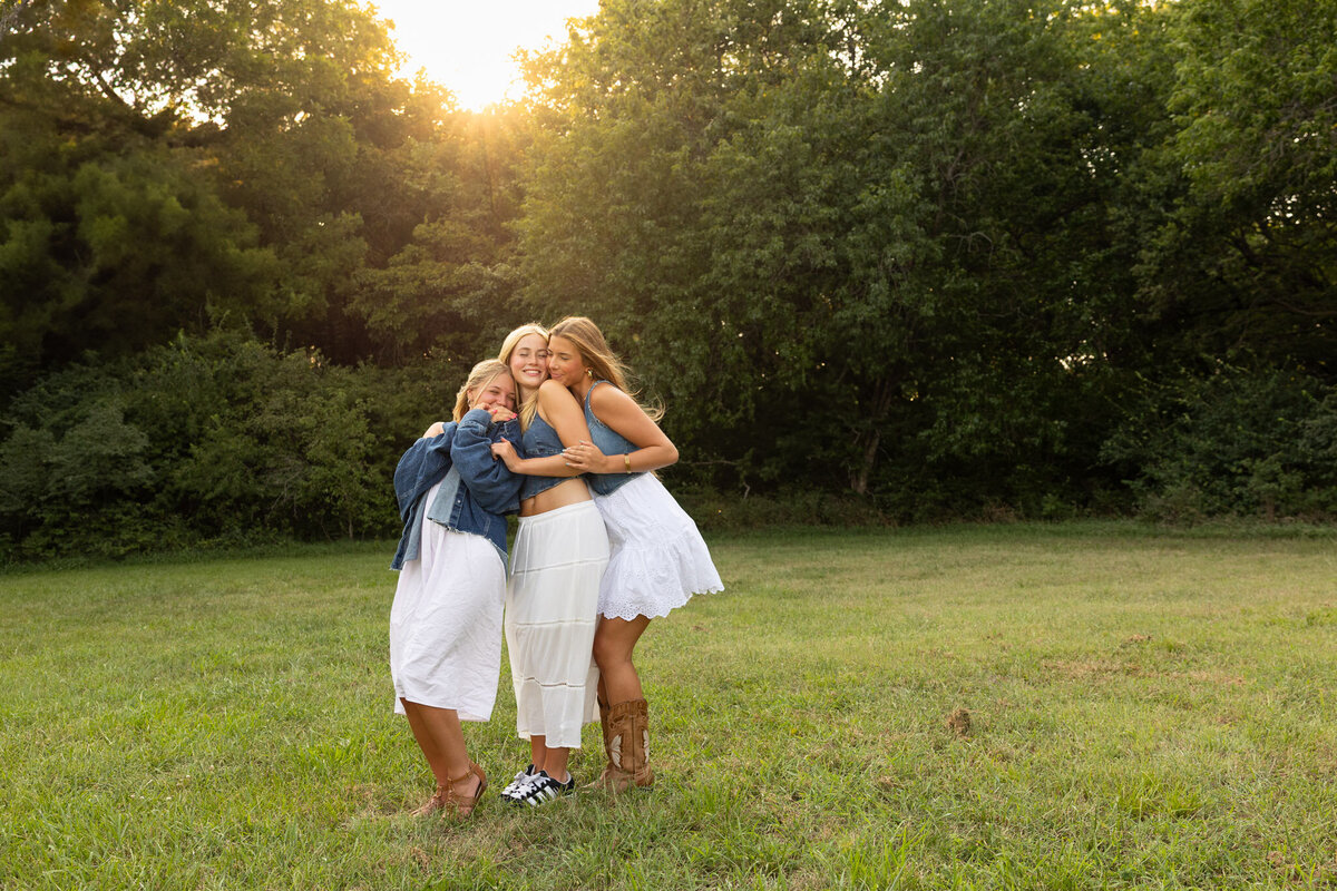 MBP Senior Team standing in a line giving each other a hug from behind during golden hour in Lawrence, KS