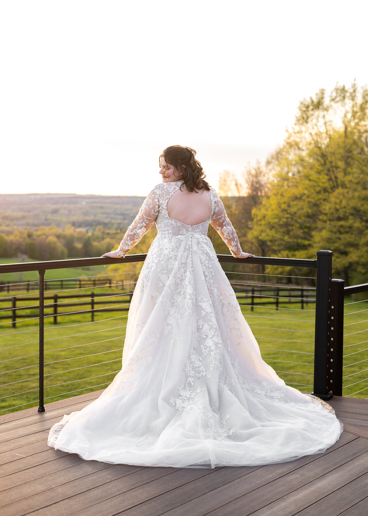 bridal portrait showing off back of dress overlooking valley of Letchworth State Park in New York