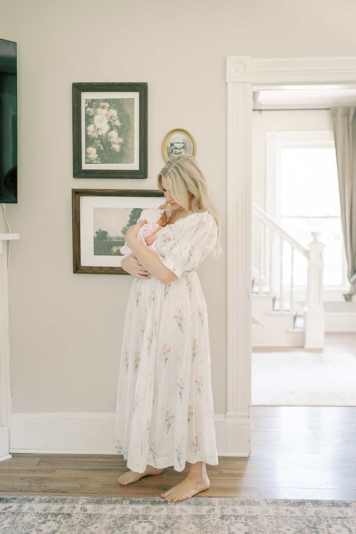 Mom holding and rocking newborn baby in Williamsburg Va