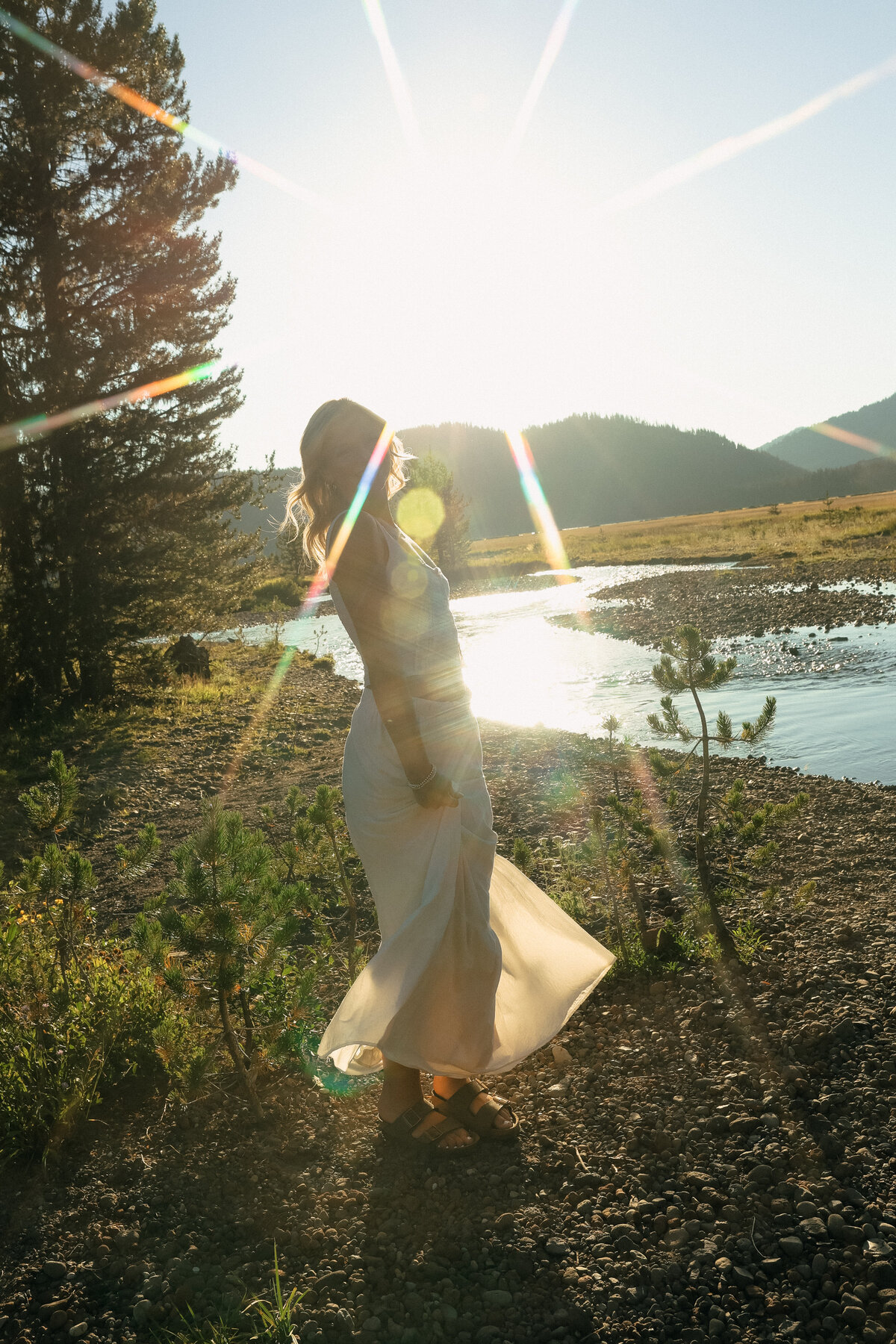 Artistic Senior Portrait of Three Friends Sitting Beside River with Mountain Views in Oregon
