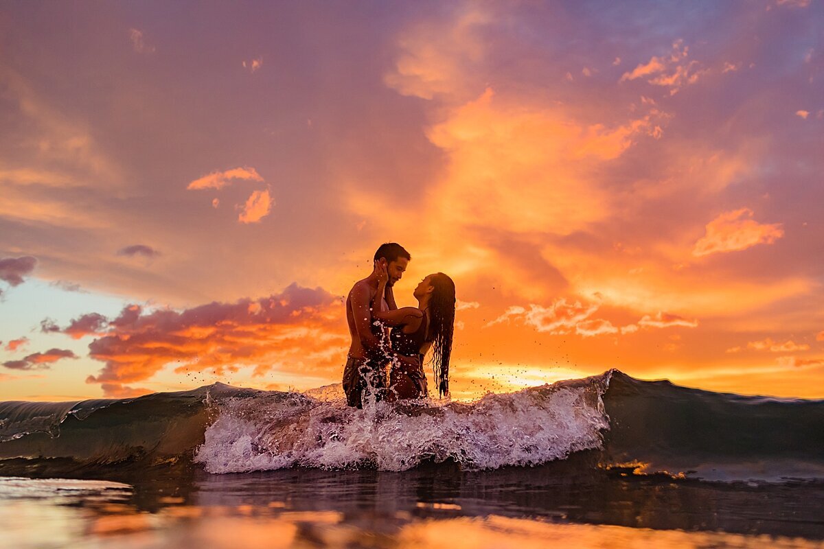 Couple in the ocean in Maui for their proposal photography session with Love + Water