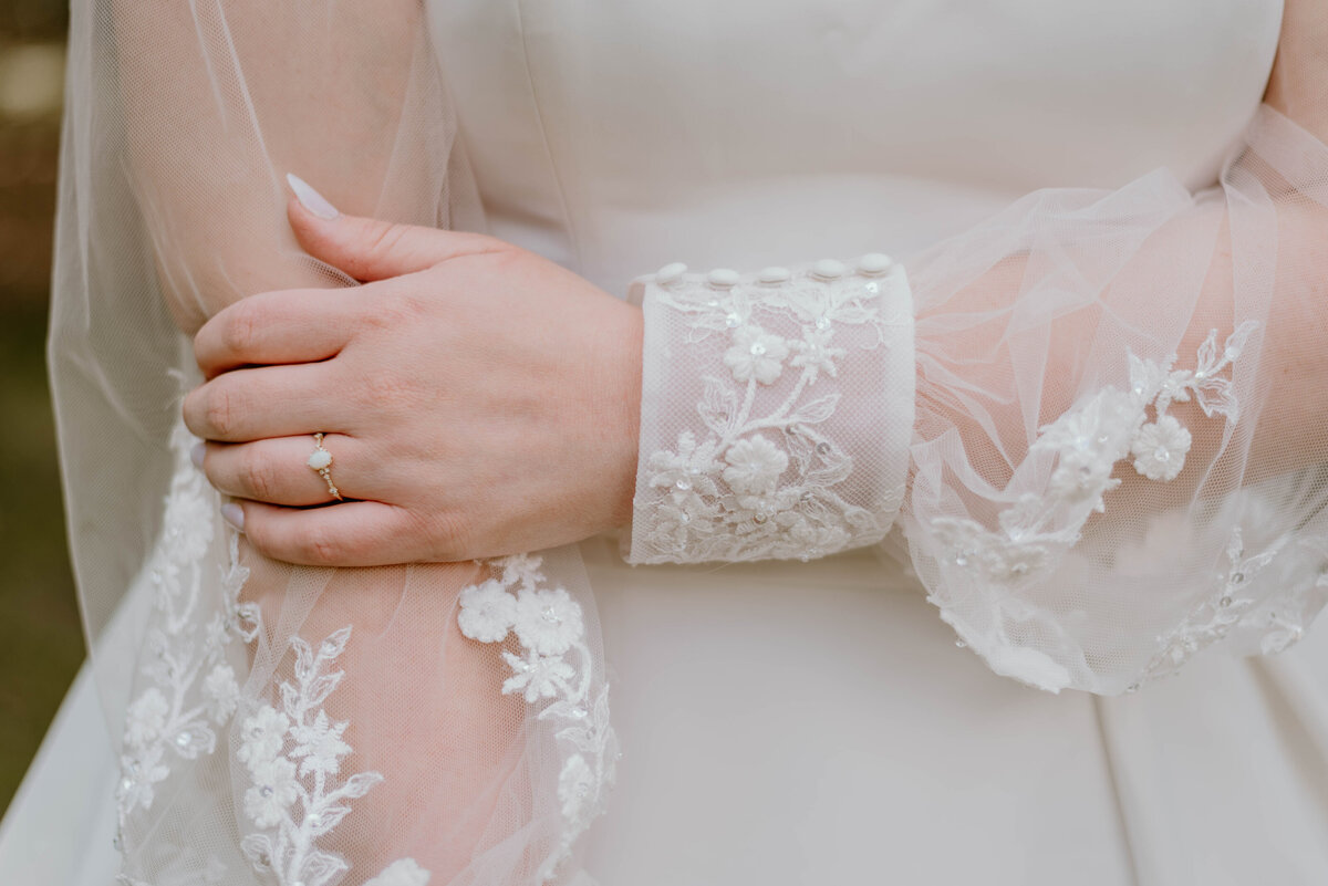 a photo displaying a brides lace detailed wedding dress.
