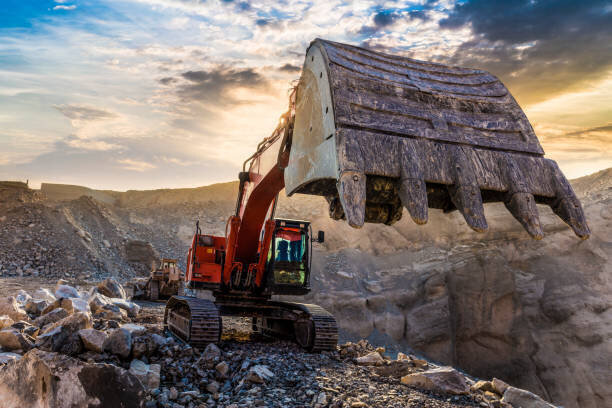 Excavator digging rock.