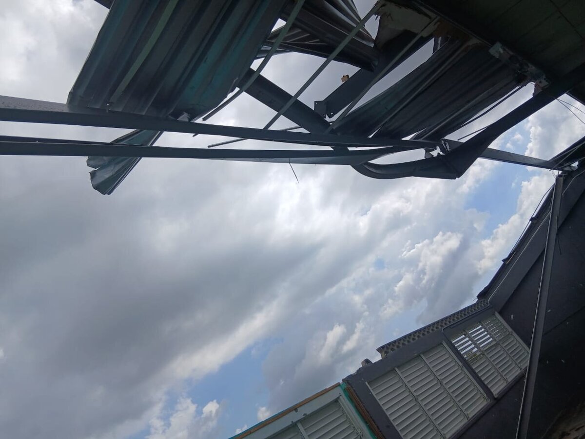 Damaged metal roofing at Barbary Hall Primary with sections missing and the sky visible through the structure after Hurricane Melissa.