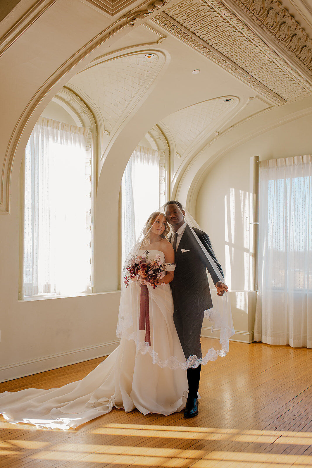 "Bride and groom celebrate their elegant luxury wedding at the historic Cottonwood Hotel in Omaha, NE – timeless moments captured by Tori Nichole Photography. A perfect blend of sophistication, romance, and architectural charm, showcasing the couple's love story in an unforgettable setting.
