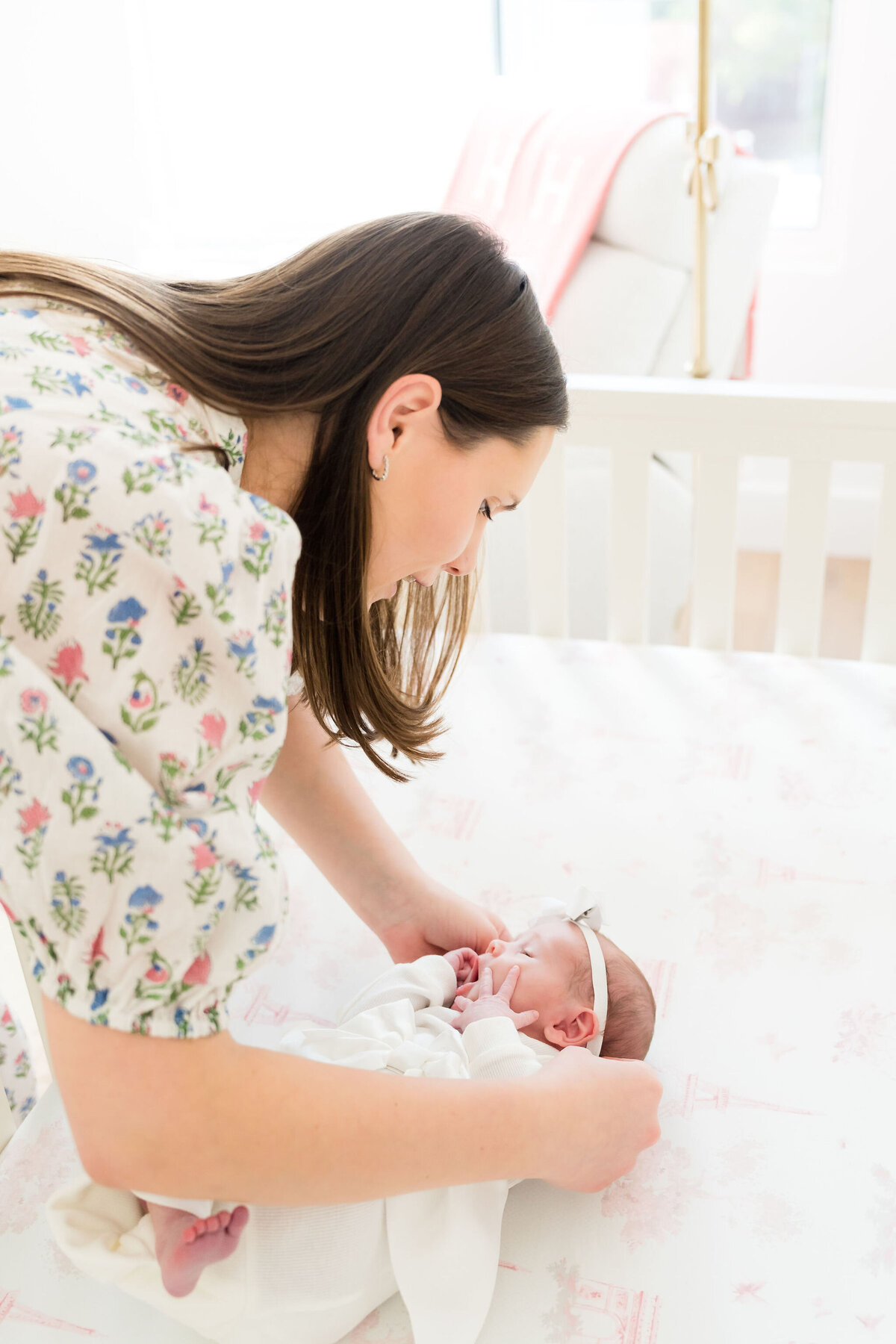 Newborn asleep in crib during in-home session.