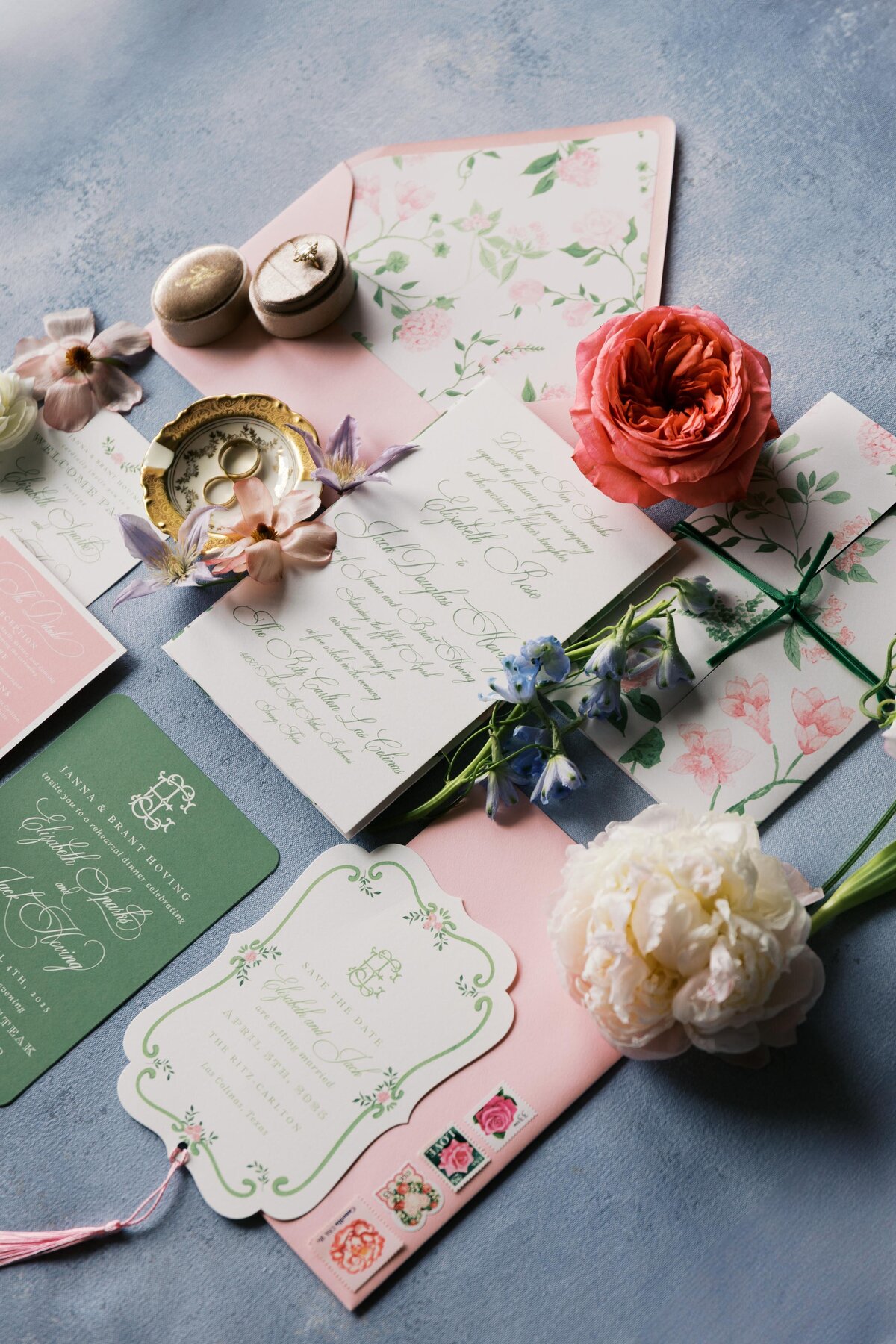 Flat lay of custom wedding invitation suite with floral accents in Dallas