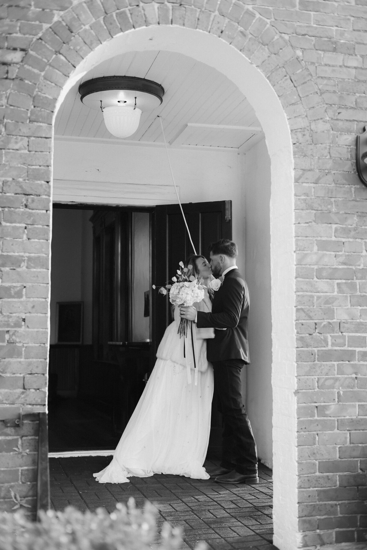 Editorial Wedding Image with Bride Veiled and Groom in Tux