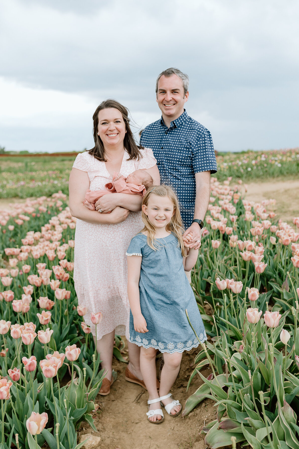 A family poses for their family photos in the tulip fields in Illinois.