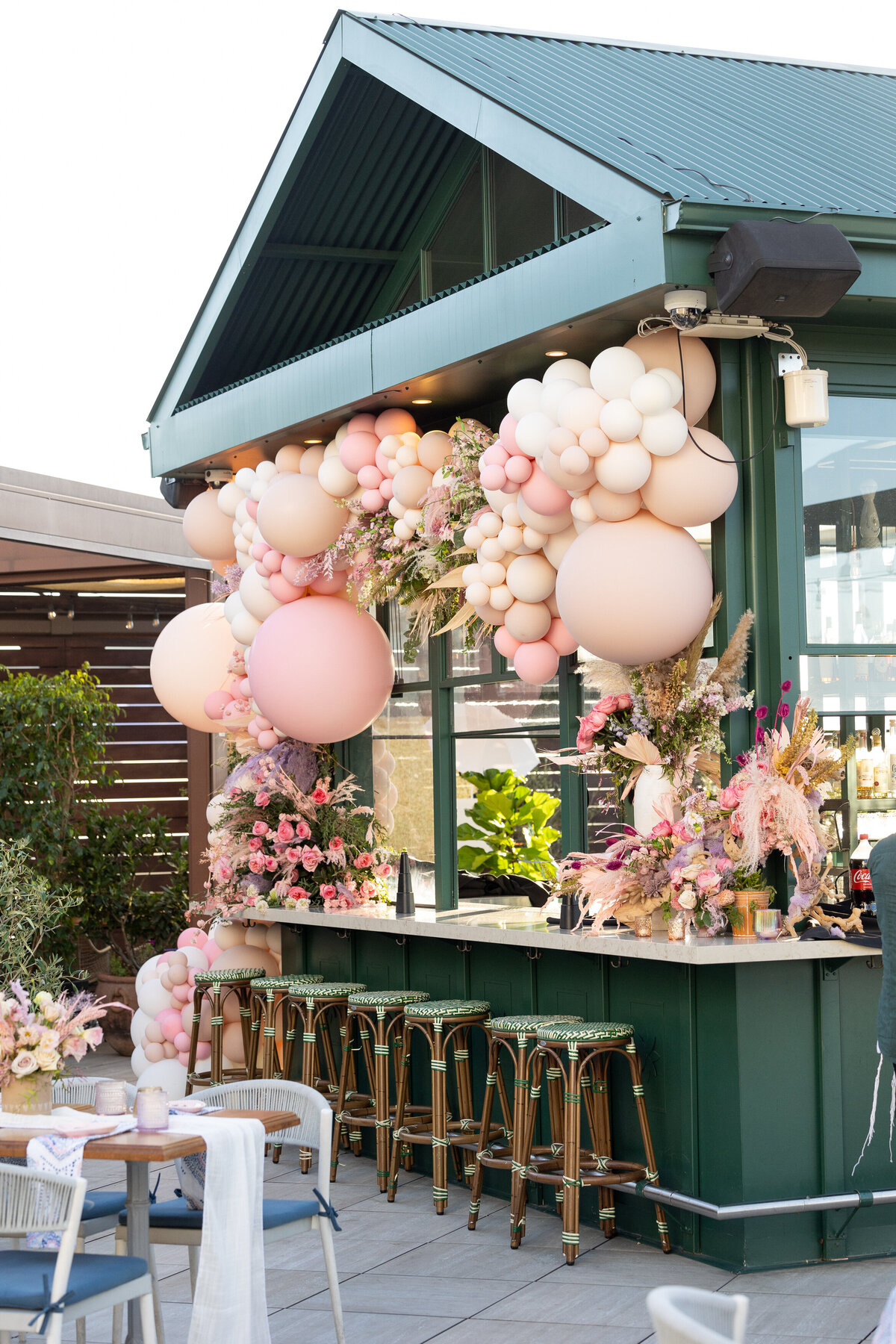 A bar with pink balloons all over it