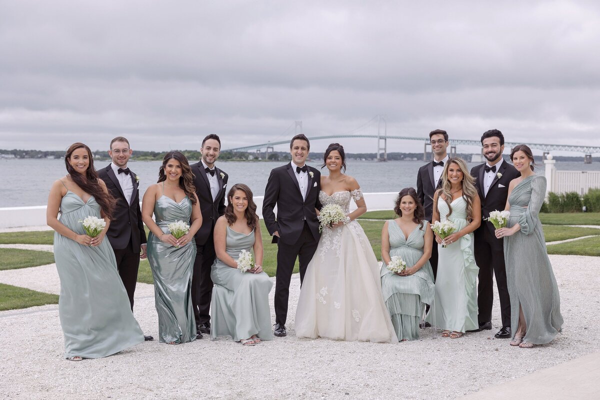 Bride and Groom pose with wedding party at Belle Mer Newport.