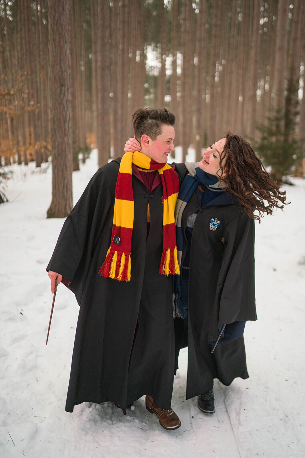 Queer Couple in snow dressed in harry pottter outfits in New York state