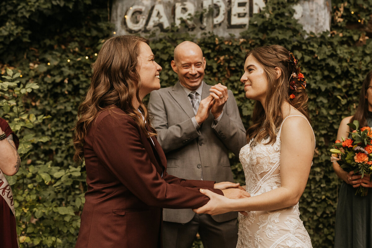 A newlywed couple holding hands during their wedding ceremony 