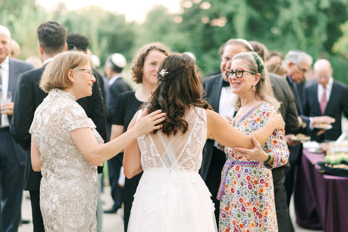 bride greets guests during cocktail hour