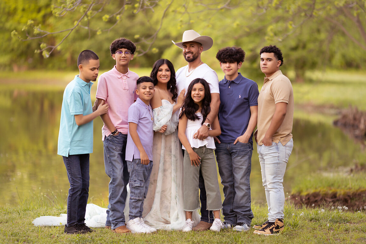 A beautiful Dallas family portrait by the water, featuring a joyful family with kids, captured by a Dallas family photographer.