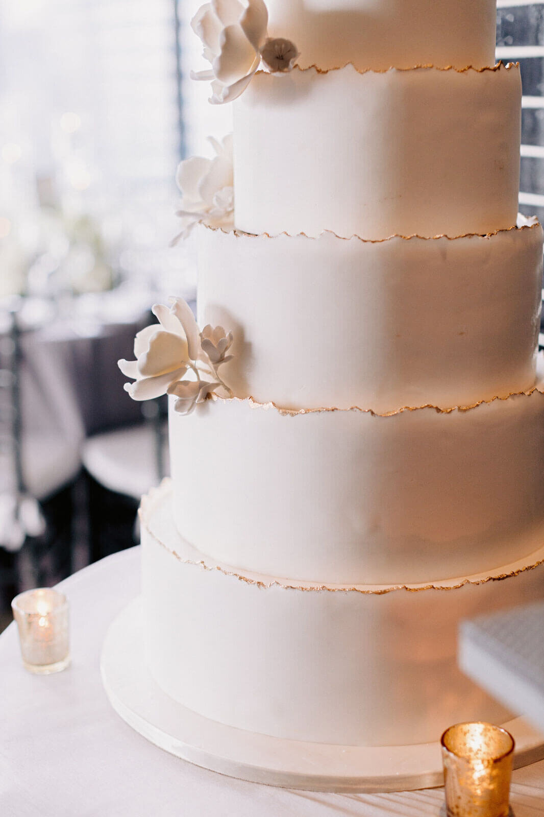 A large, monochromatic, white wedding cake in The Skylark, New York. Wedding Image by Jenny Fu Studio