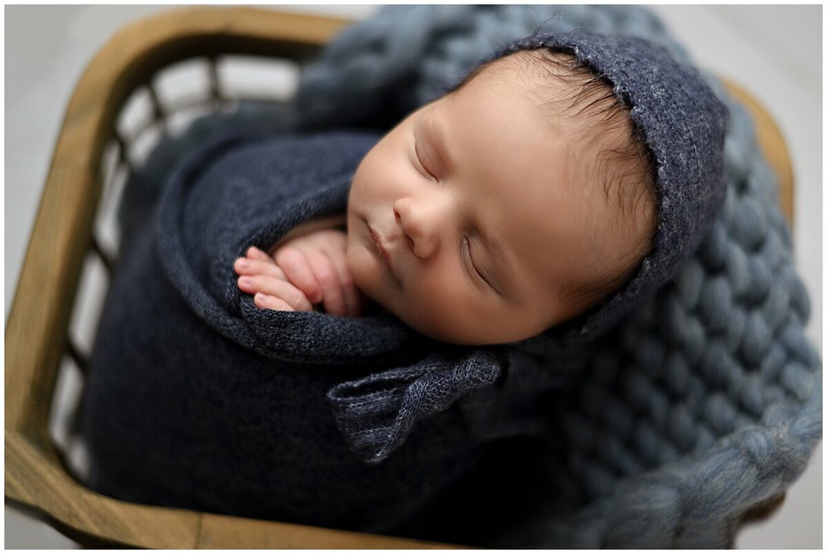 Newborn baby boy asleep in basket