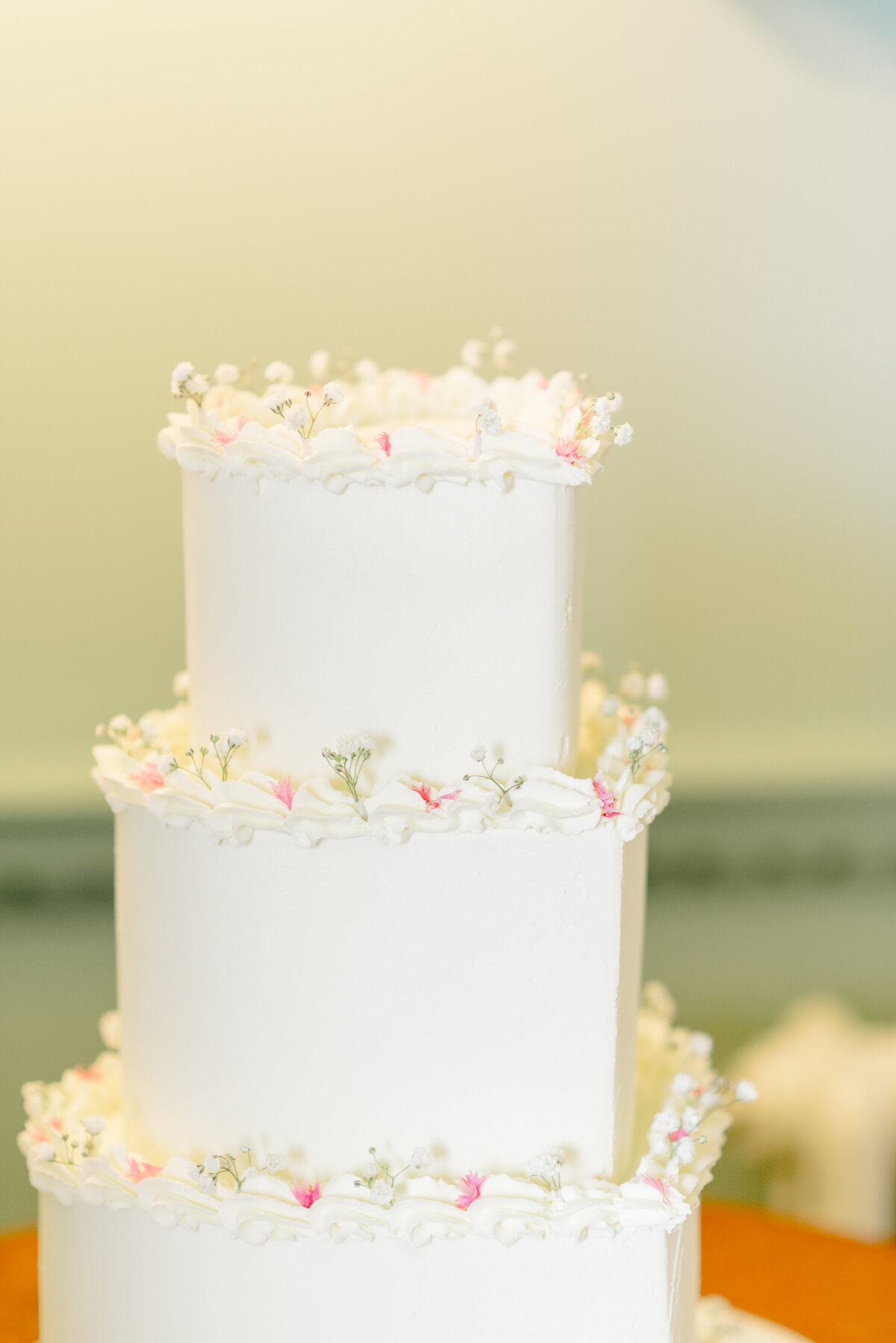 Elegant summer delicate design wedding cake at Cromlix House, captured by destination wedding photographer in Scotland.