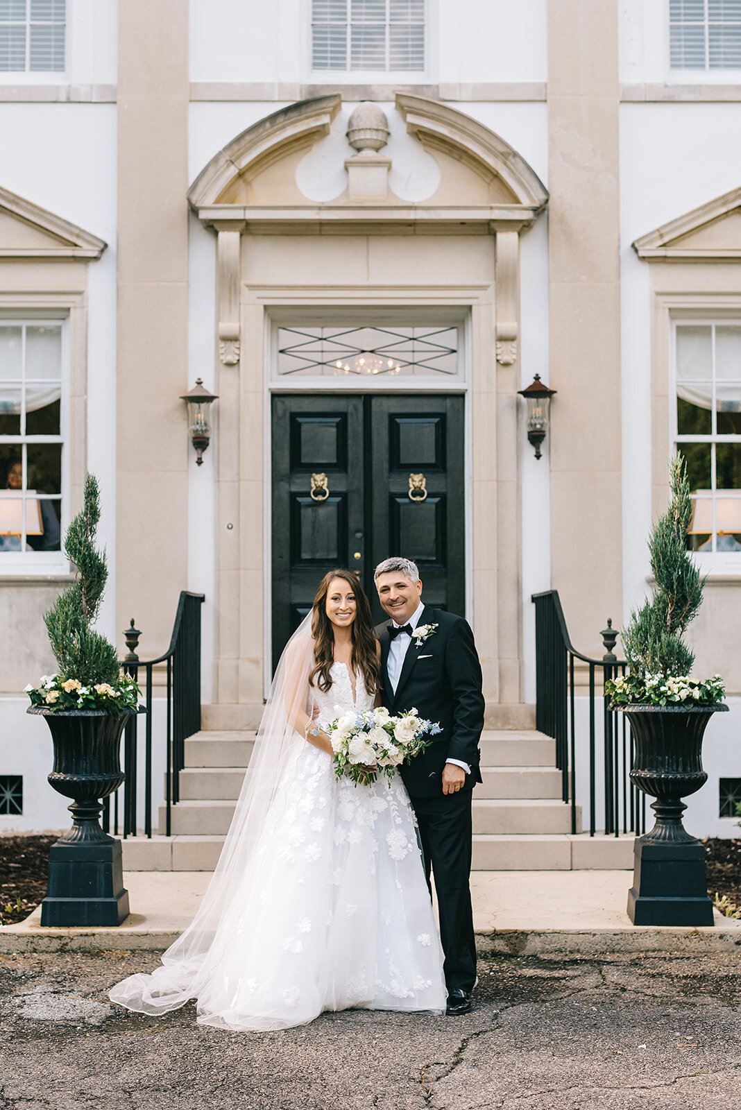 Bride and groom with white and blue bouquet designed by Abby Grace Florals at Greenville SC wedding
